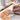 Artist using a Fuumuui size 1 Detail Brush to paint a dog portrait with watercolor paint on cold press paper. A size 6 Round brush and ceramic palette are nearby. Ideal for professional artists and beginners.
