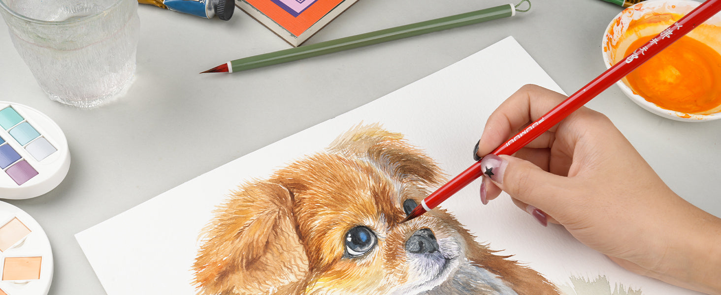 Artist using a red FUUMUUII detail brush to paint a dog on cold press watercolor paper. Features a Kolinsky sable Chinese calligraphy brush, watercolor paint set, and ceramic palette for professional artists.