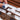 Individual plastic pigment wells being removed from a Fuumuui Art wooden travel palette. Portable watercolor paint set with removable pans, ideal for professional artists and beginners.