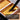 A round watercolor brush dipping into metallic gold pigment in a pearlescent watercolor paint set pan. High-shimmer pearlescent texture for professional artists and beginners to create dazzling artworks.