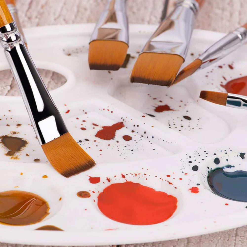 Fuumuui nylon hair acrylic brushes on a paint-stained palette, showing them in use for art painting.