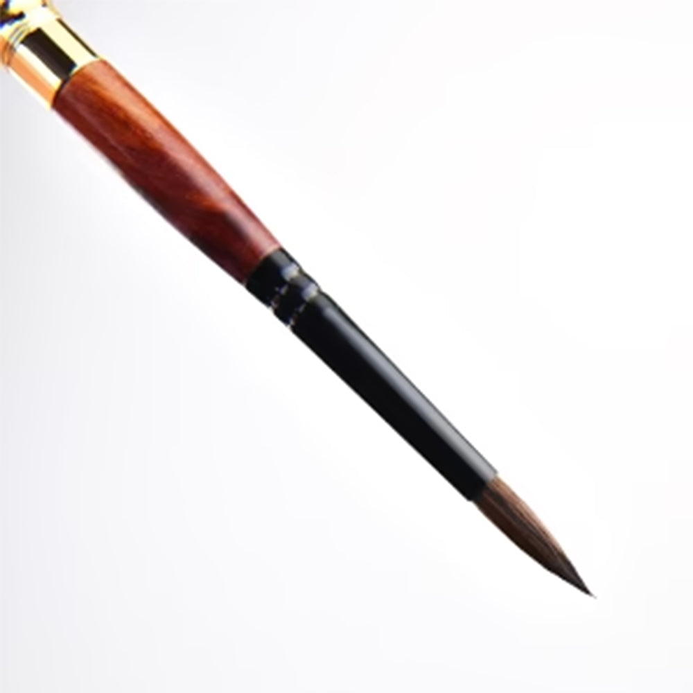 The brush has a wooden handle, a gold-colored ferrule, and a black section leading to the brown, pointed squirrel hair bristles.