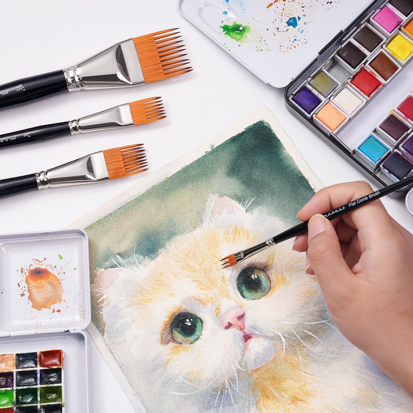 An artist using a small flat comb brush to add fur texture to a watercolor painting of a cat.