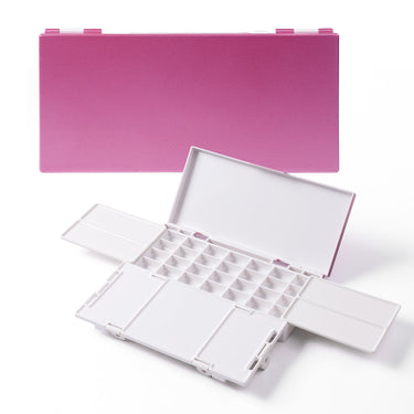 Fuumuui airtight paint palette tray in metallic pink, shown both closed and open, revealing 28 empty wells and foldable mixing trays for watercolor, gouache, and acrylic art supplies.