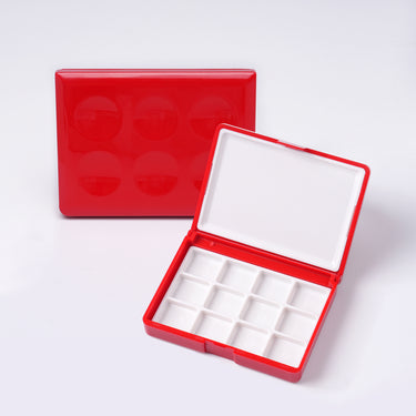 Fuumuui Art Supplies red plastic portable paint palette box with lid for watercolor, open to show 12 mixing wells and a white mixing surface.