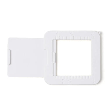 White plastic adjustable viewfinder tool with aspect ratio markings for framing and composition, ideal for professional artists and beginners working with watercolor, acrylic, or oil paint.