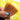 Close-up of Kolinsky Sable watercolor brush bristles fanning out over a yellow pigment wash on textured cold press paper. High-quality natural hair brush for professional artists and watercolor painting.