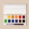 Fuumuui Portable 12-color solid watercolor paint set, open to display vibrant paint pans, built-in palette wells, and an included brush.