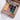 Fuumuui Travel Palette with a 12-color pigmented Watercolor Paint Set in a frosted Plastic Palette, attached to a brown leather sketchbook binder. Portable art tool for professional artists and beginners.