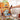 Fuumuui Comb Brush Flat used by a professional artist to paint a textured autumn landscape with acrylic paint. Scene includes paint tubes and a wooden palette on an easel, perfect for beginners and pros.