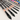Fuumuui 5pcs Professional Squirrel Hair Watercolor Brushes with black handles and rose gold ferrules, displayed alongside a colorful watercolor paint palette.