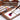 Size 8 watercolor brush blending magenta pigment on the enlarged ceramic mixing area of a wooden travel palette. Portable watercolor paint set for professional artists and beginners on the go.