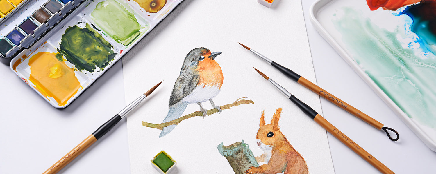 Fuumuui Kolinsky Sable detail brushes size 1 and 2 used to paint a watercolor bird and squirrel on cold press paper. Set includes a professional watercolor paint set and white ceramic palette for artists.