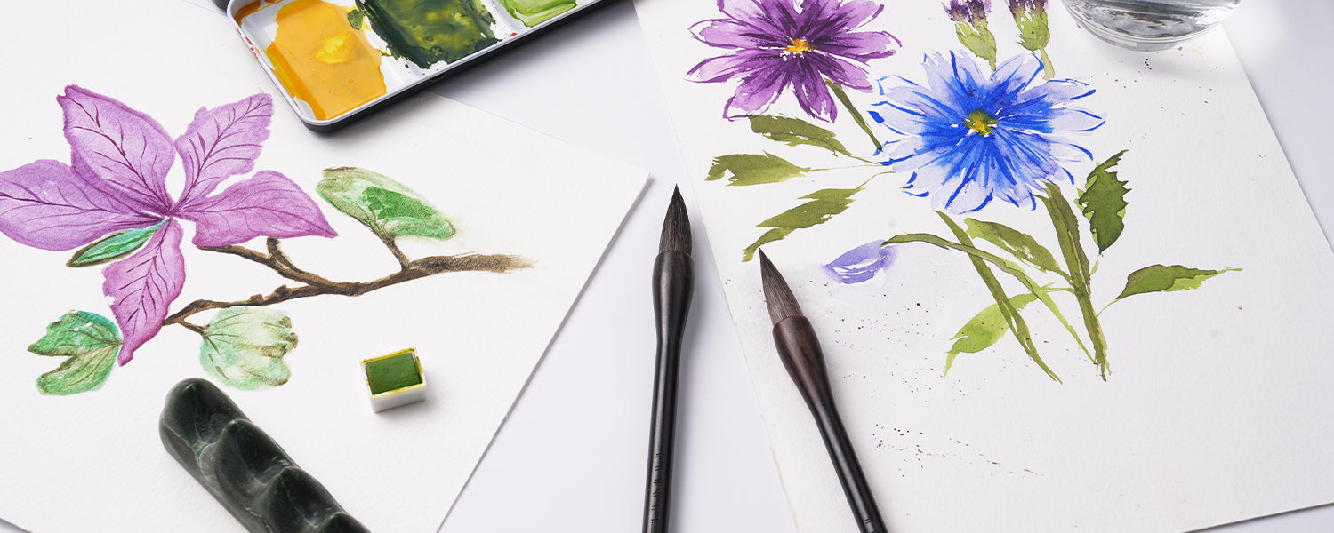 Squirrel hair Chinese Calligraphy Brushes on Cold Press watercolor paper with floral paintings, a travel watercolor paint set palette, and professional brush rest for artists and beginners.