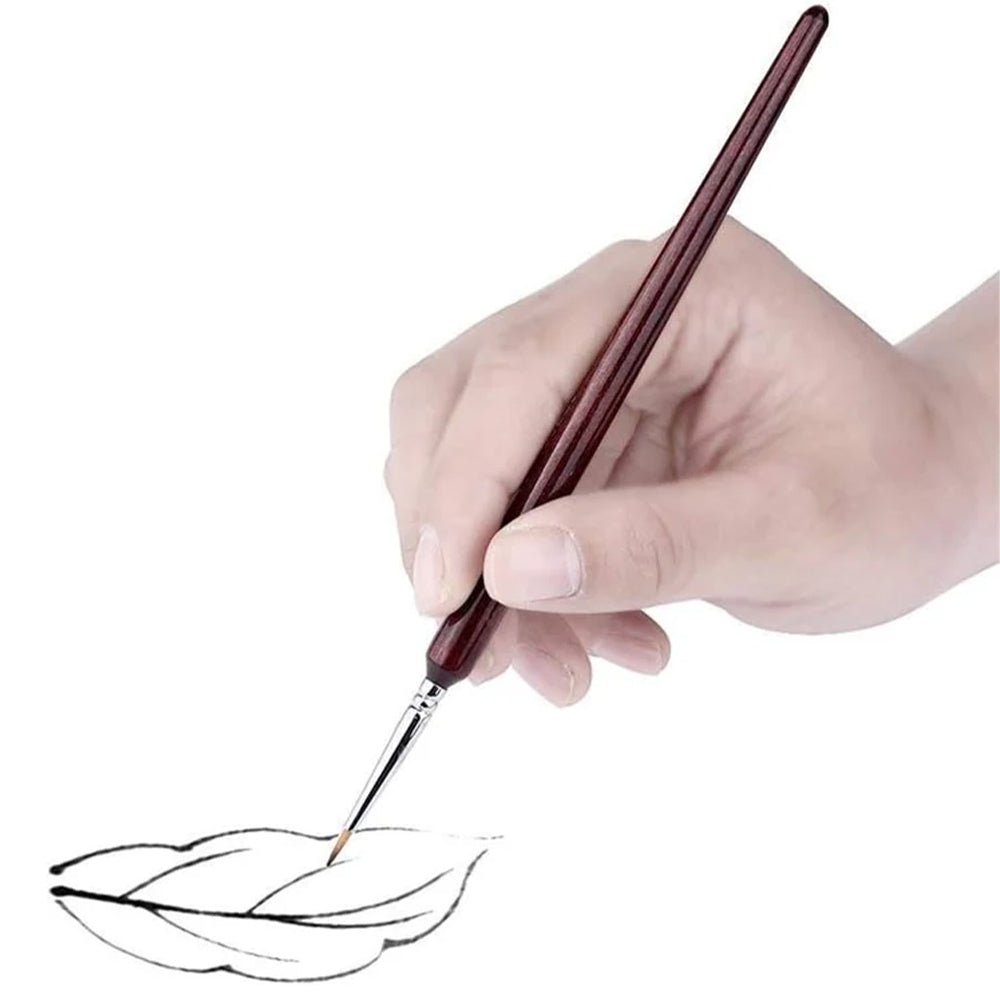 A person using a Fuumuui professional detail brush to paint thin, precise lines for fine-point art.