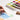 Professional artist using a Chinese Calligraphy Brush for watercolor painting on cold press paper. Set includes squirrel hair brushes and a ceramic palette with watercolor paint for detailed artistic work.