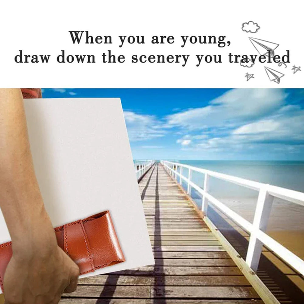 A hand holding a Fuumuui travel brush case and a canvas, ready to paint a scenic wooden pier over the ocean.