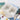 Fuumuui white two-compartment ceramic paint brush wash bowl, perfect for watercolor and acrylic painting, shown with a paintbrush and palette.