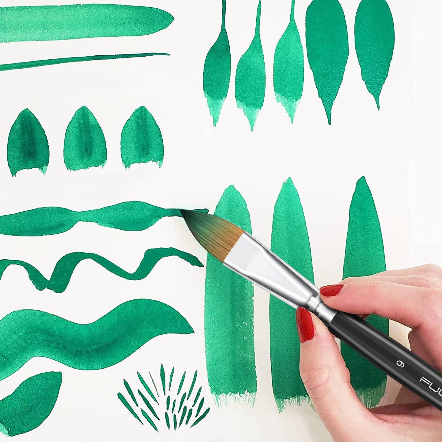 Fuumuui cat's tongue oval wash brush creating different green watercolor strokes and leaf shapes.