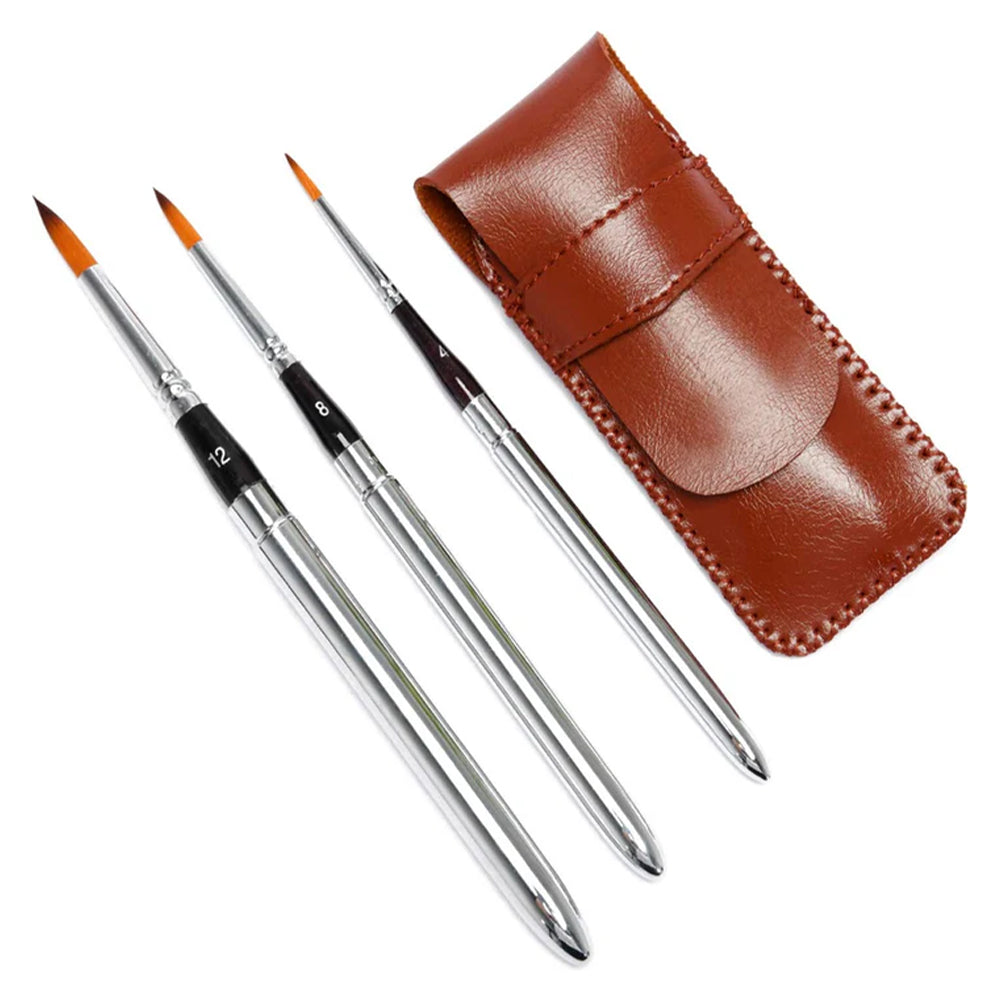 A set of three Fuumuui portable travel watercolor brushes with a sleek silver design and a brown leather case.