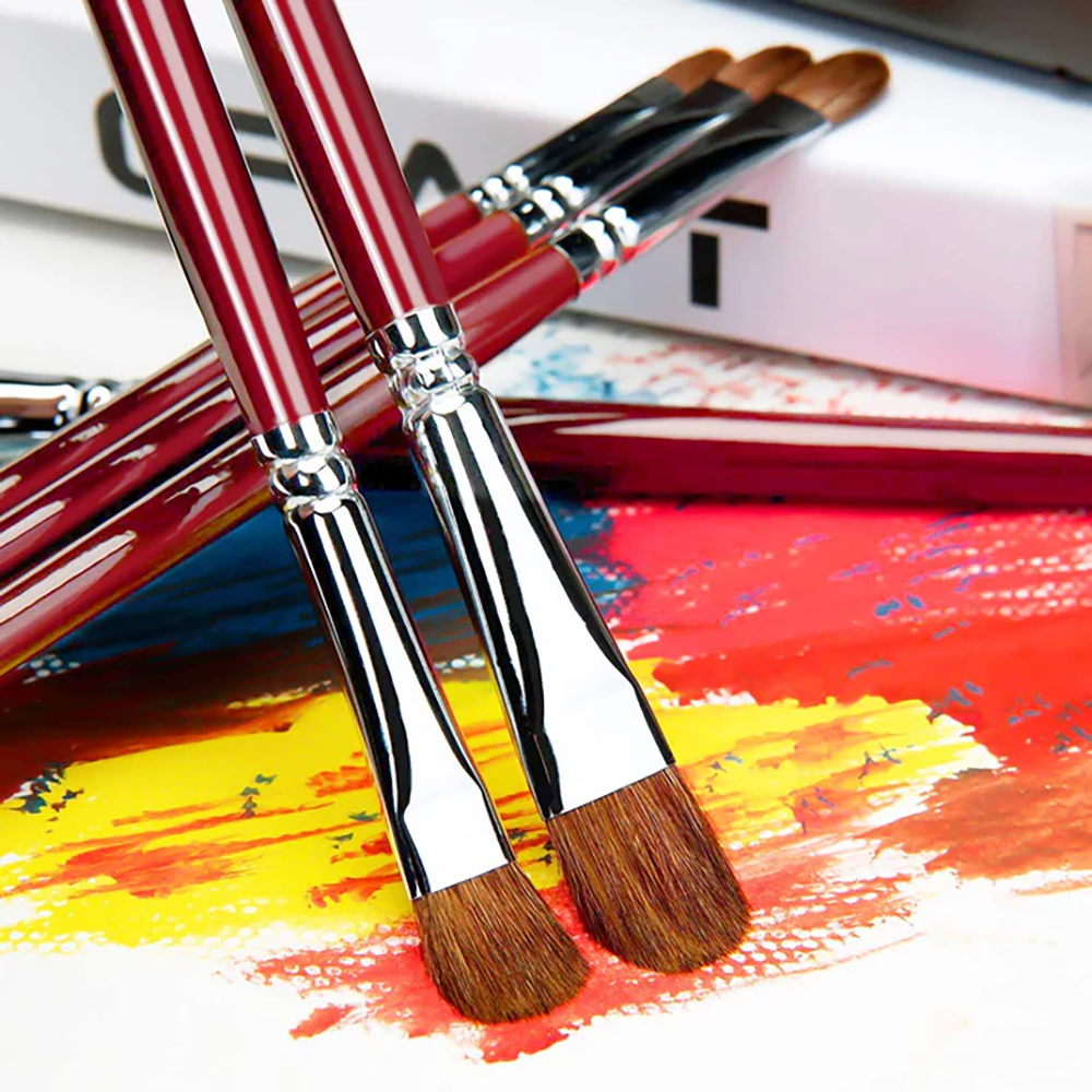 Fuumuui artist quality filbert paint brushes for acrylic and oil, showing the sable hair bristles and chrome ferrules on a canvas.