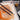 Fuumuui professional watercolor brushes set featuring two synthetic goat mixed hair paint brushes dipped in a glass of water on a paint-stained white palette, suitable for watercolor, acrylic, and gouache art.