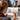 Fuumuui Art Supplies: Artist using a Fuumuui Travel Watercolor Brush from the 5Pcs Professional Plein Air Set to paint a vibrant urban landscape in a sketchbook.