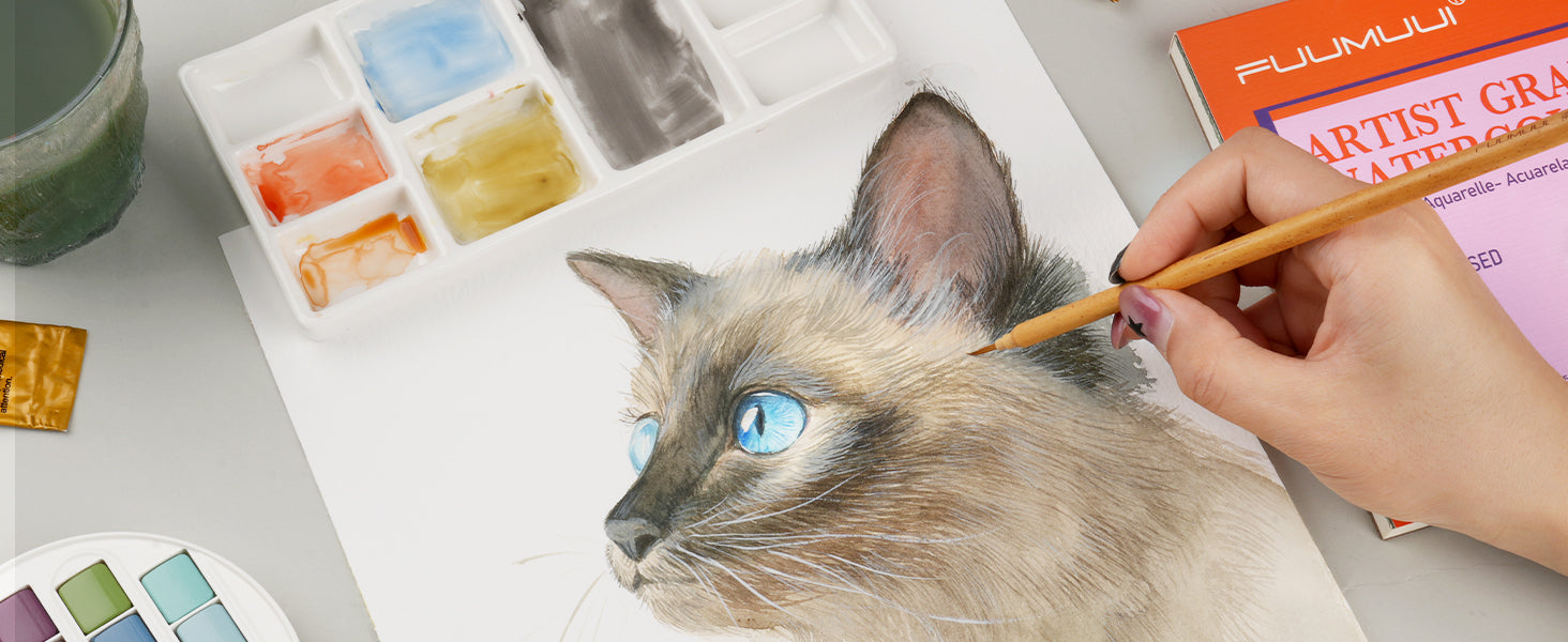 Professional artist painting a cat portrait with a fine watercolor detail brush on Fuumuui Artist Grade cold press paper. Includes a ceramic palette and miniature paint brush for realistic watercolor details.