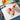 Fuumuui Art Supplies A4 20-sheet acrylic and oil painting pad in use, with an artist painting vibrant pink flowers, ideal for students, beginners, and professional painters.