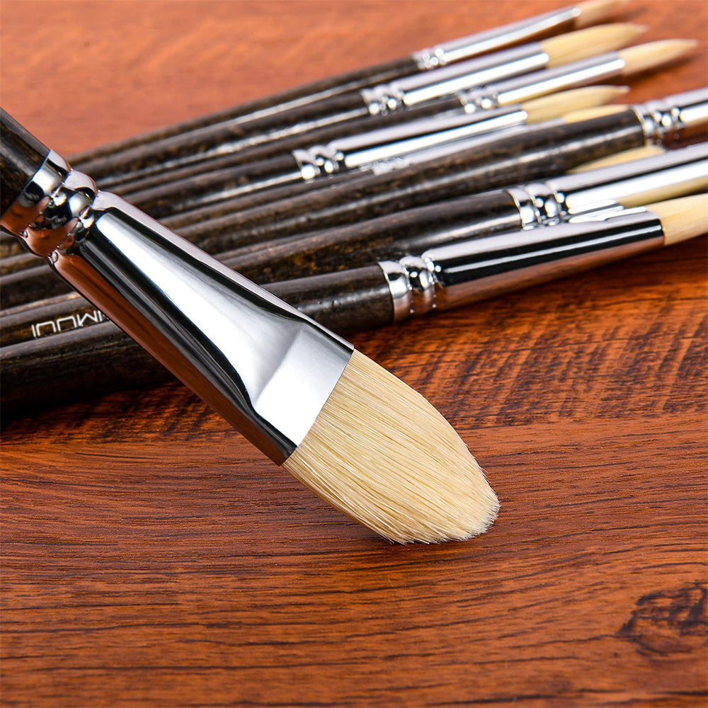 A hog bristle paint brush on a wooden surface, high quality of the natural bristles and craftsmanship.
