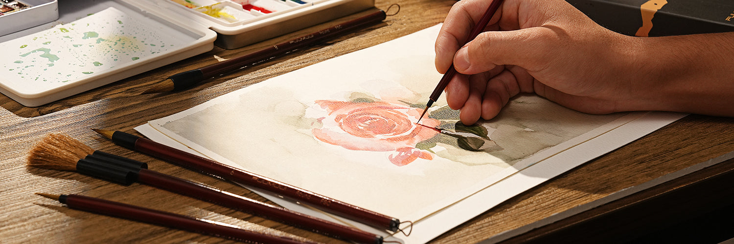 Professional artist using a Kolinsky Sable detail brush on 100% cotton cold press paper. Fuumuui watercolor brush set featuring natural hair mop brushes and a ceramic palette with watercolor paint pigments.