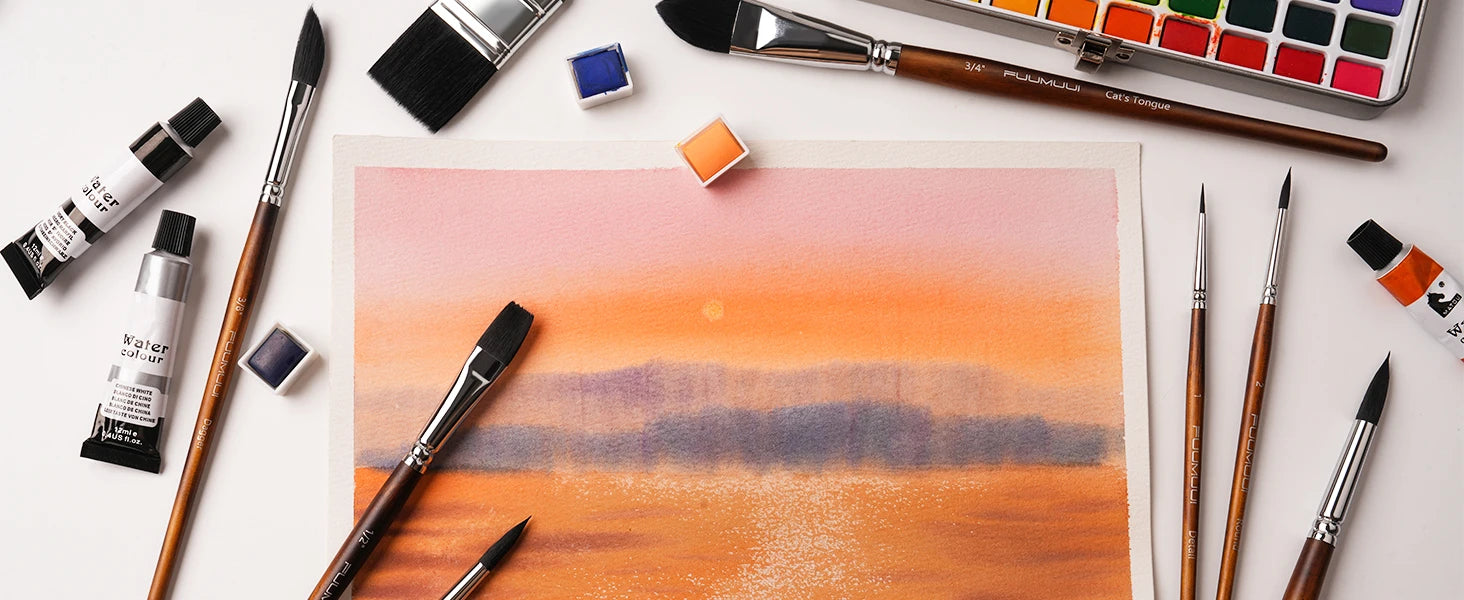Fuumuui 10pcs synthetic squirrel hair watercolor brush set with 3/4" Cat's Tongue, 3/8" Dagger, Oval Wash, Flat, and Detail brushes around a sunset painting on cold press paper with professional watercolor paint tubes.
