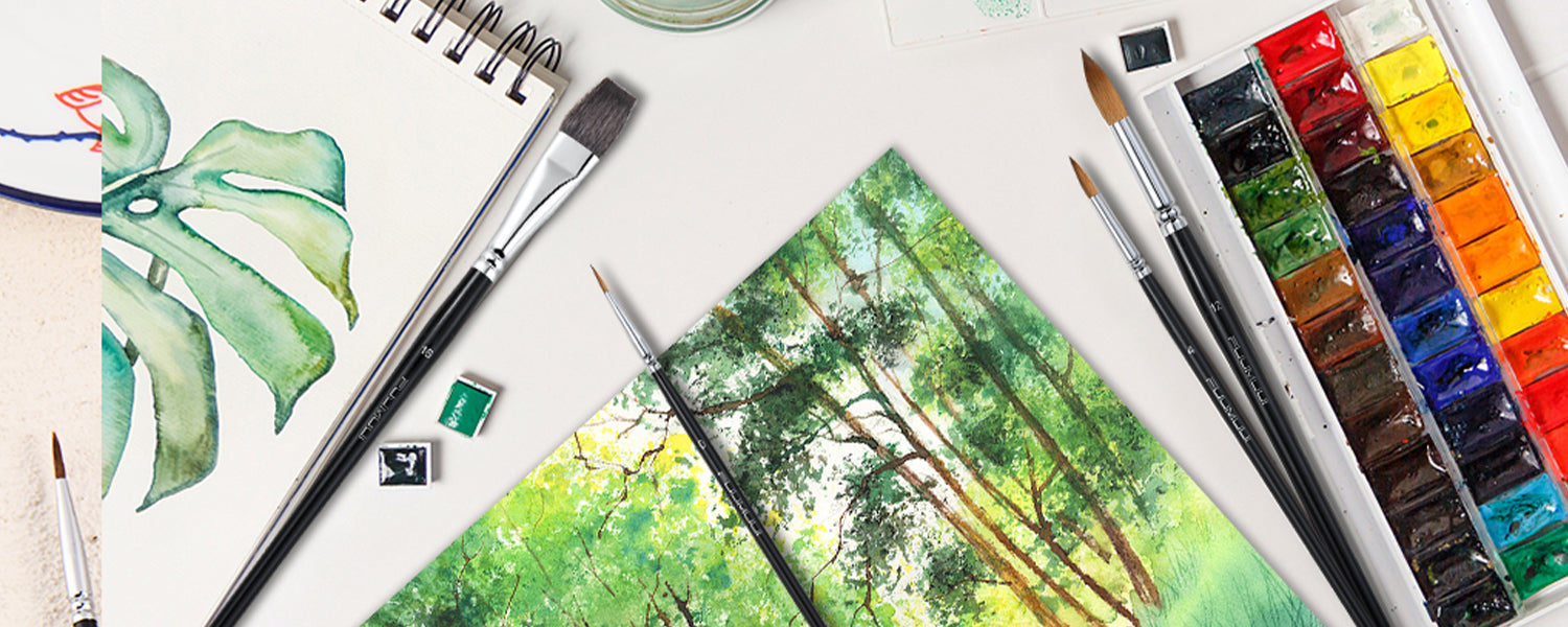 Professional watercolor brush set with squirrel hair flat brush size 18, Kolinsky sable round brushes size 12 and 4, and detail brushes on cold press sketchbook with a watercolor paint set and forest landscape art.