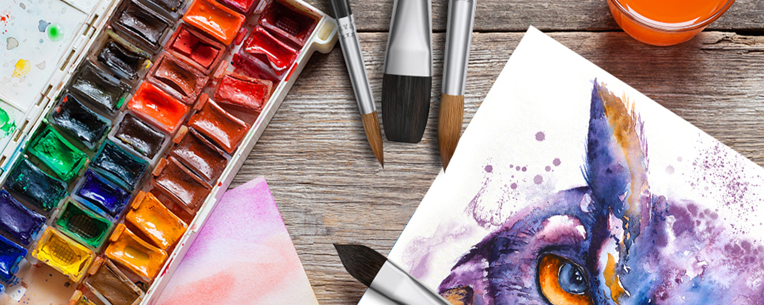 Professional watercolor brushes including round pointed, flat, and cat's tongue shapes, displayed with a watercolor paint set and an owl painting on 100% cotton cold press paper for professional artists.