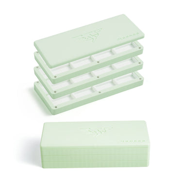 Mint green Fuumuui 3-tier empty paint palette box shown open with pan compartments alongside a closed box.