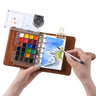 Artist painting a seascape on Fuumuui travel sketchbook set with 24 semi-solid paints and dual-tip brush.