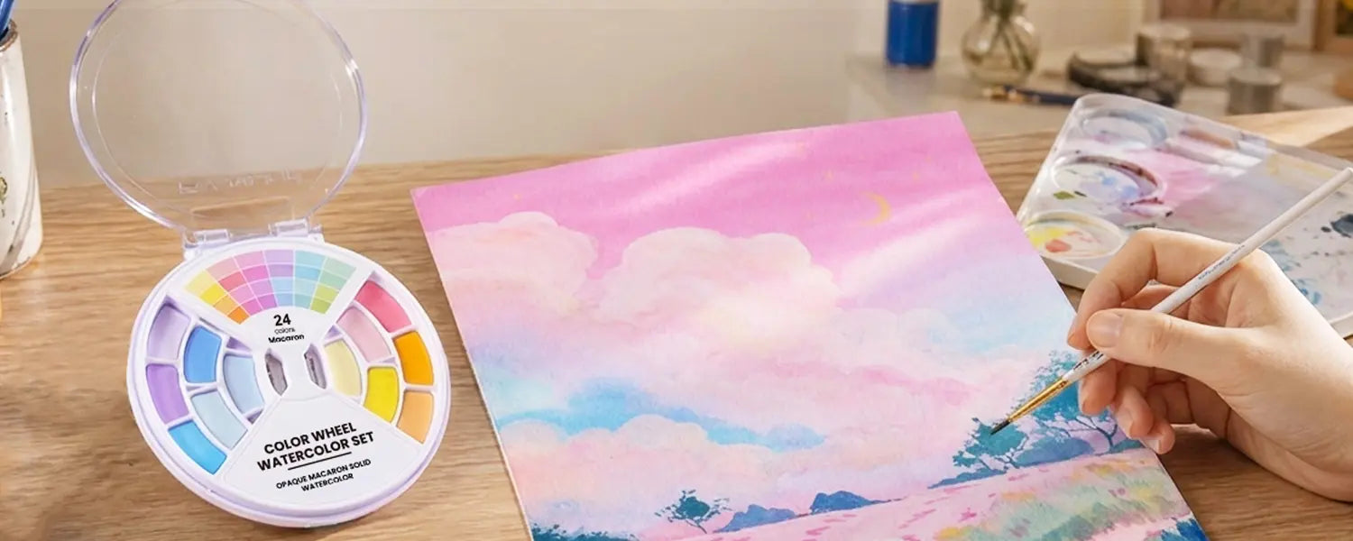 An artist painting a sky landscape using soft pastel shades from the Fuumuui Color Wheel Watercolor Set.