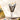 Fuumuui hog bristle paint brushes organized in a ceramic cup beside a landscape oil painting.