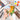 Fuumuui travel watercolor brushes and leather case arranged around a colorful street landscape painting.