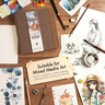 Fuumuui 8.25 inch square cotton watercolor sketchbook surrounded by mixed media art, paints, and brushes.
