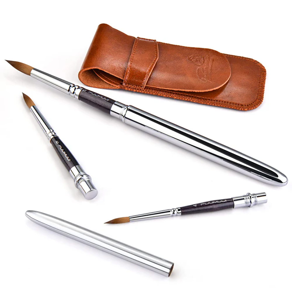The sable watercolor brush set arranged with its leather case, showing the brushes both capped and uncapped.