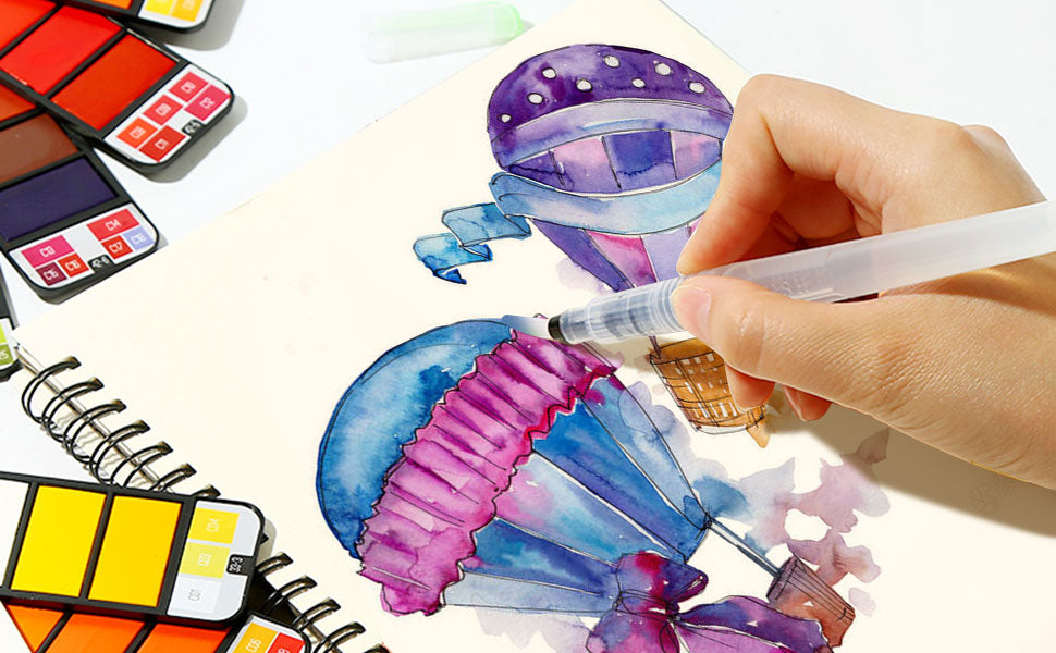 Artist using a synthetic nylon travel watercolor brush to paint in a cold press sketchbook. Portable watercolor paint set with pigment swatches and travel pocket kit for beginners and professional artists.
