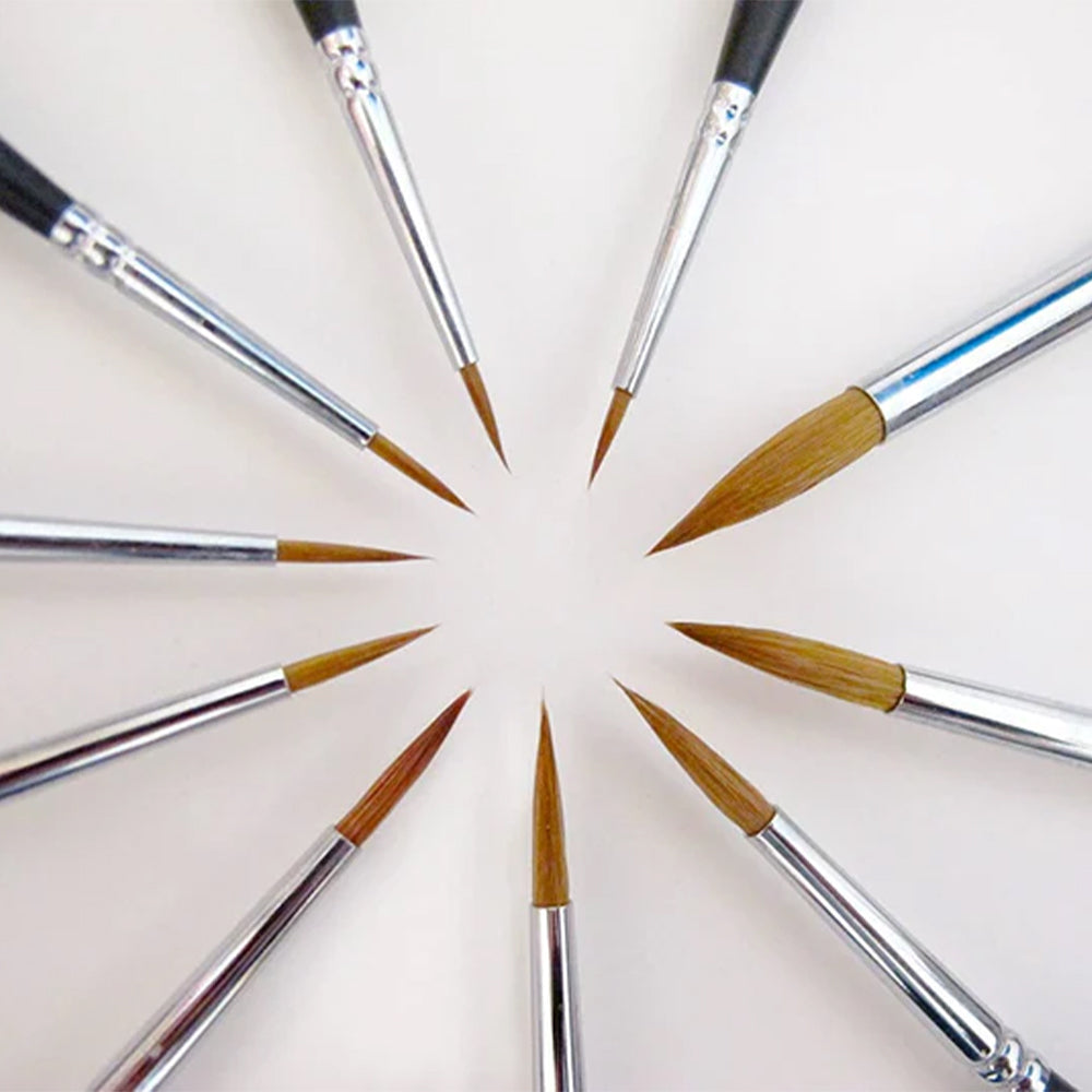 A circle of various sizes of Fuumuui sable detail brushes, showcasing their different tips for precision painting.