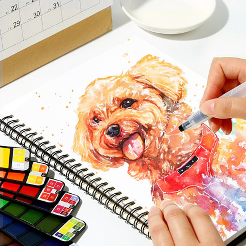 An artist paints a watercolor portrait of a fluffy dog using a refillable water brush from a portable watercolor kit on a sketchpad.