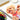 Fuumuui Travel Portable Watercolor Set Assorted Colors Pocket Kit in use, with an artist painting a vibrant dog portrait on a sketchbook using a water brush pen.