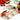 Fuumuui Travel Portable Watercolor Set Assorted Colors Pocket Kit in use, painting a vibrant autumn illustration of a girl with a red umbrella and falling leaves with a water brush pen.