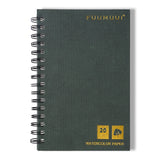 Fuumuui Art Supplies watercolor sketchbook with dark green textured, spiral-bound cover, highlighting 20 sheets of 100% cotton paper.
