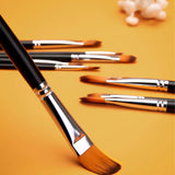 Fuumuui 9pcs Professional Nylon Hair Acrylic Brushes - Filbert, featuring multiple filbert-tip brushes with orange bristles, black handles, and silver ferrules, displayed on an orange background.