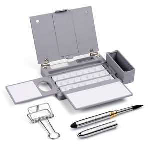 Gray Travel Palette with white mixing surfaces and empty pans. Set includes two Fuumuui silver Travel Watercolor Brushes: a size 1 Detail Brush and a size 10 Round Brush for professional plein air artists.