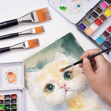 Un artista che utilizza un piccolo pennello a pettine piatto per aggiungere la texture del pelo a un dipinto ad acquerello di un gatto.